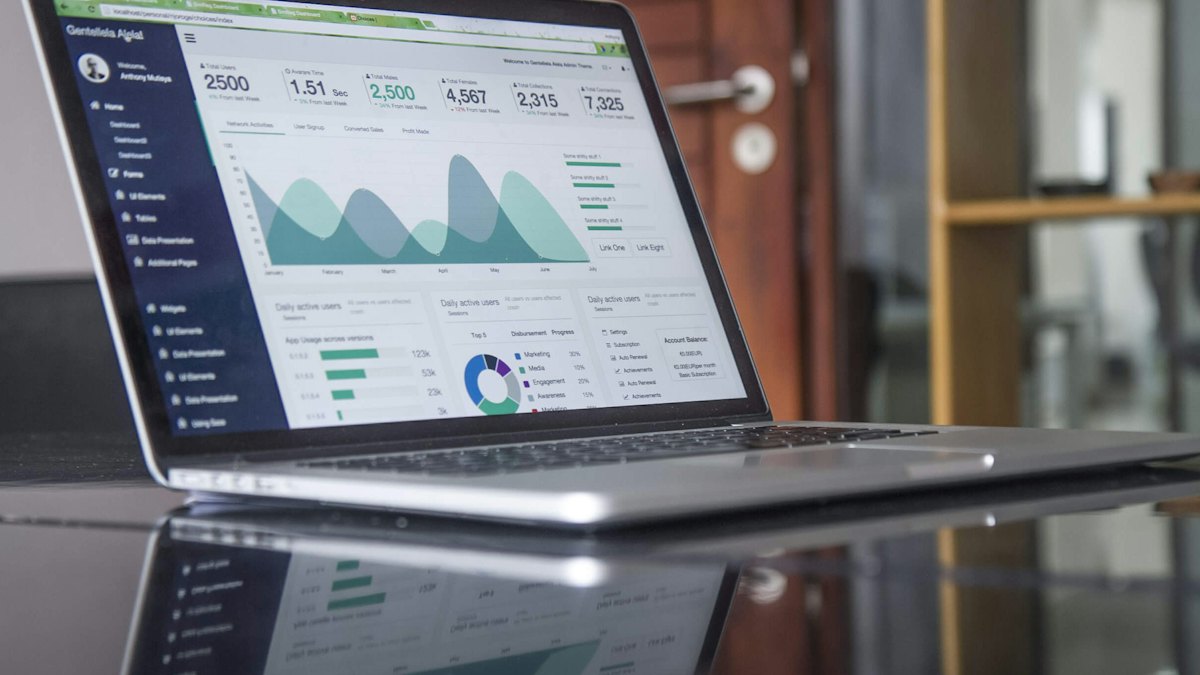 Laptop showing an analytics dashboard with charts