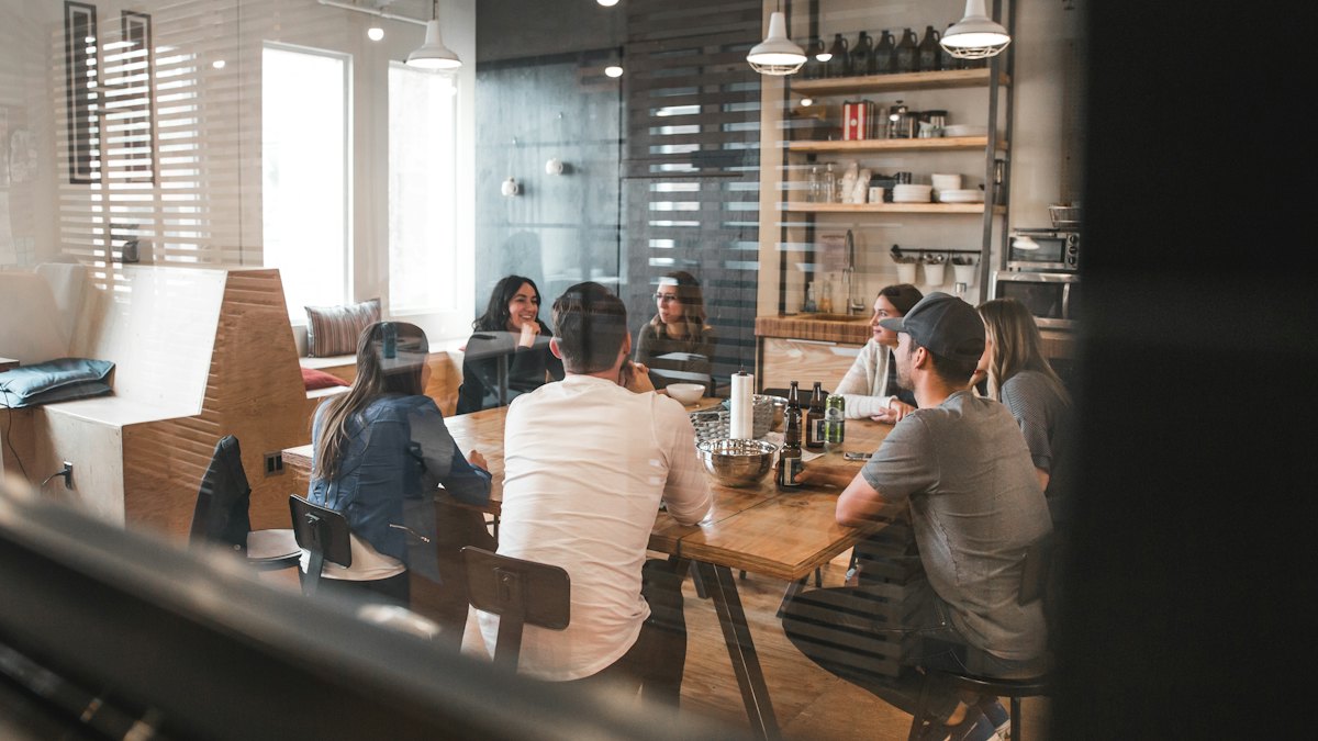 Team seated around tables working in a shared office
