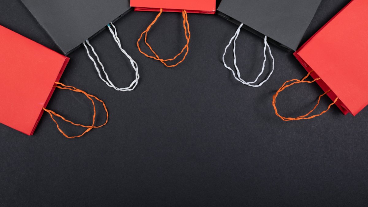 Red and black shopping bags on a dark surface
