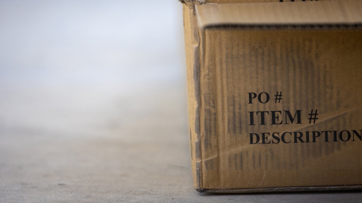 Cardboard box labeled with purchase order and item number fields